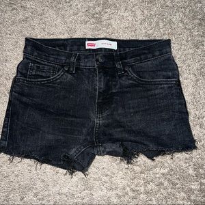 Faded black Levi’s 511 denim jean shorts. Raw hem. Incredible Fit